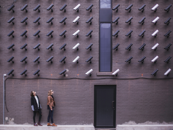 Women looking at security cameras by Matthew Henry