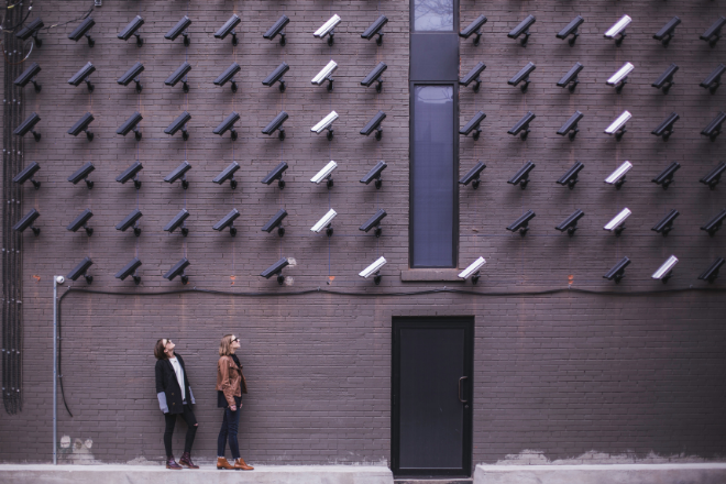 Women looking at security cameras by Matthew Henry
